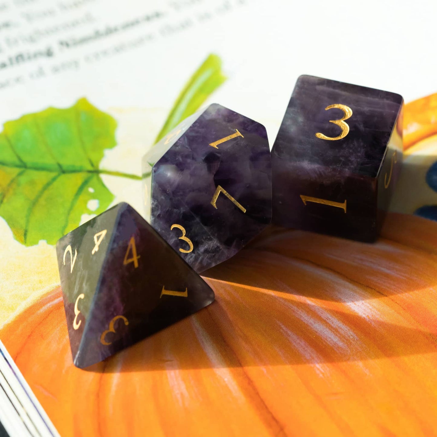 Close up of Amethyst Essence Stone Dice Set showing purple amethyst d4,d10 and d6