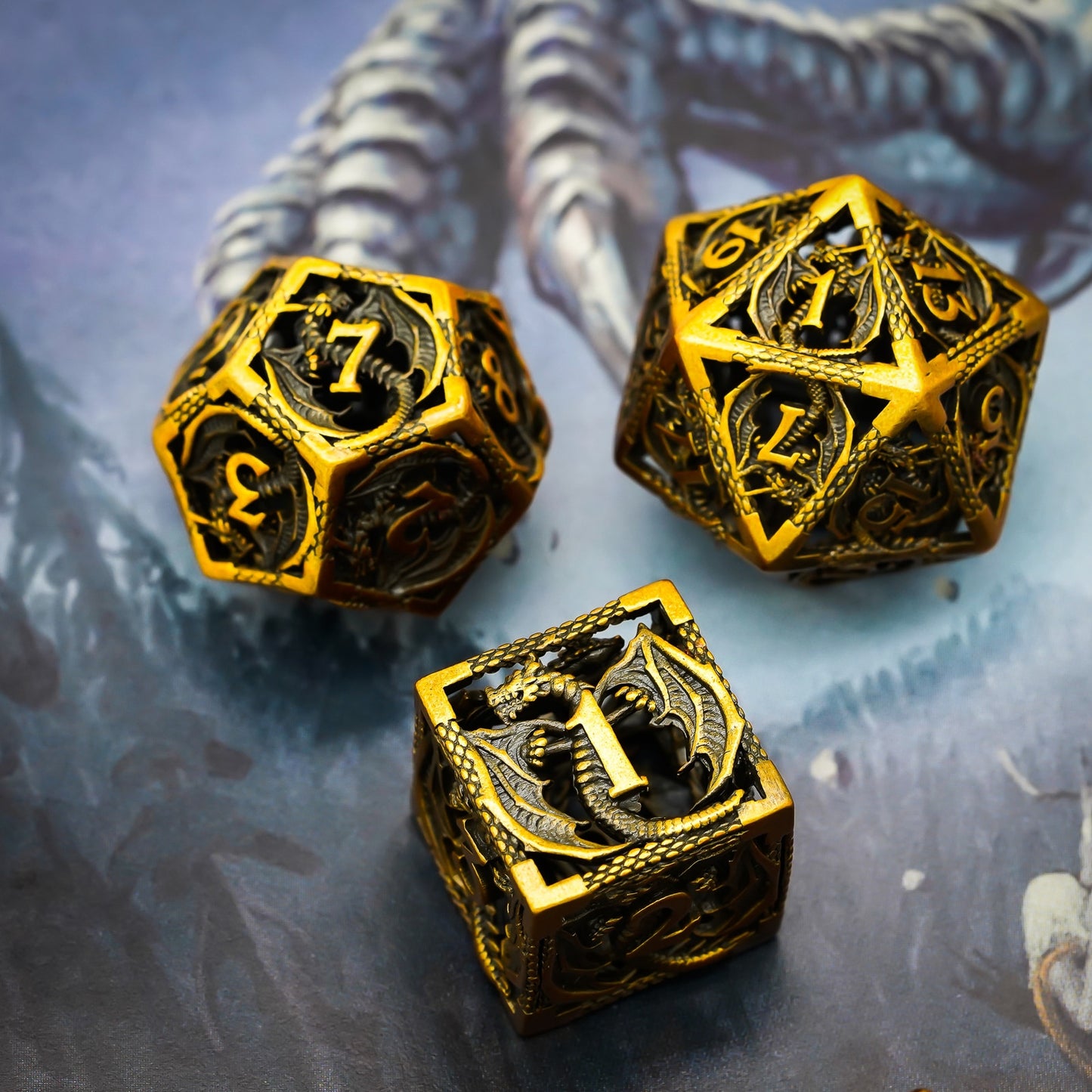 Closeup of Ancient Gold Dragon hollow dice set featuring D6 D12 and D20 on a dragon mat