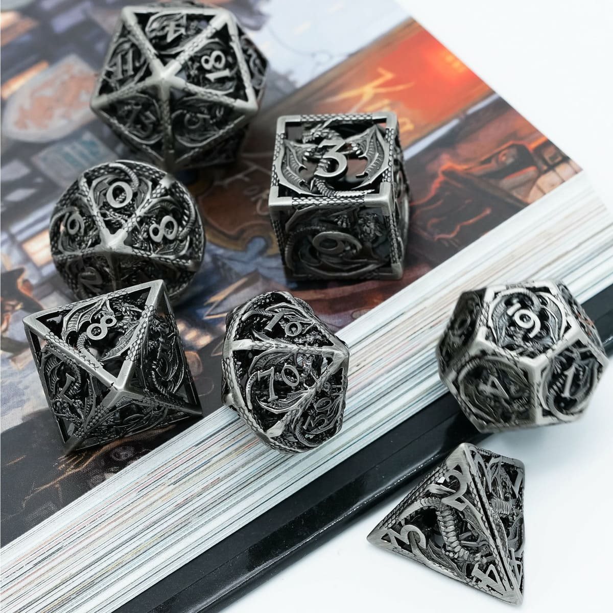 Ancient Silver Dragon hollow metal DND dice displayed on fantasy background art