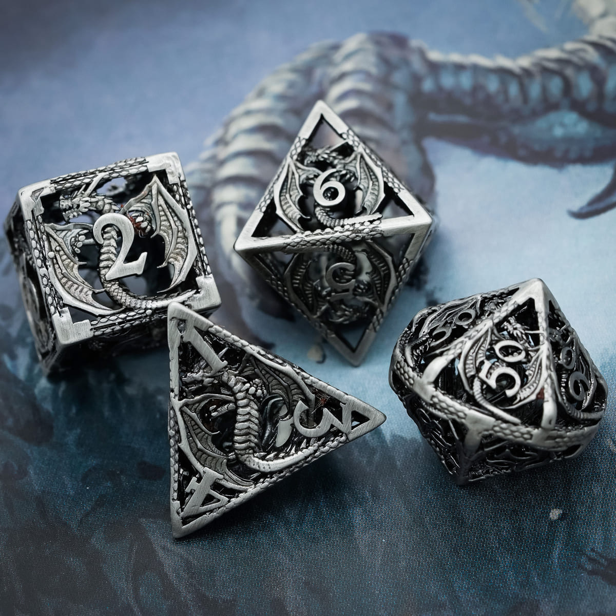 Close-up of Ancient Silver Dragon hollow metal dice set for DND and tabletop RPGs