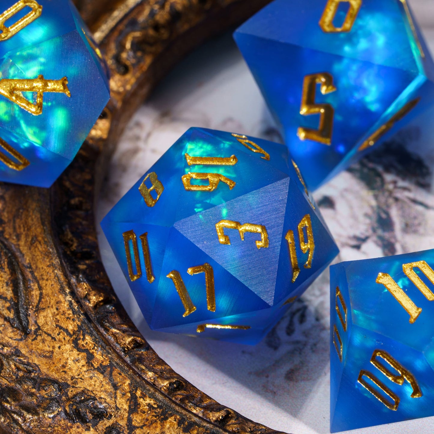 Azure Abyss sharp edge dice set with blue translucent resin and metallic gold numbering