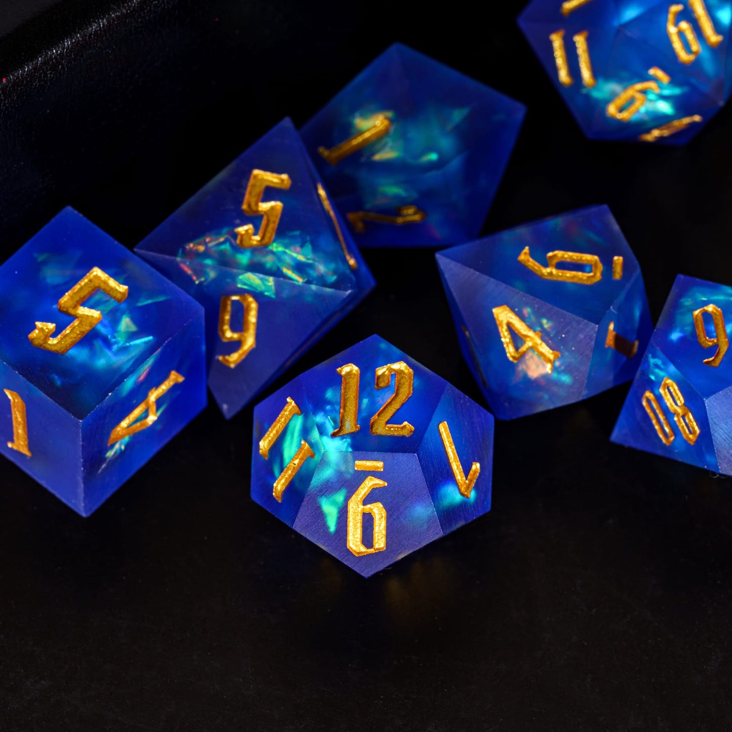 Closeup of Azure Abyss Sharp Edge Dice Set blue resin with gold numbering for DnD & DnD 5e