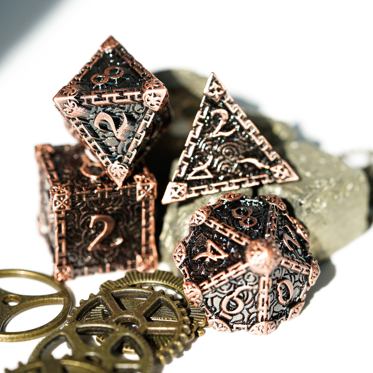 Bronze Blade metal dagger dice set with d4 and d20 closeup, bronze engraved design for DnD and tabletop RPG