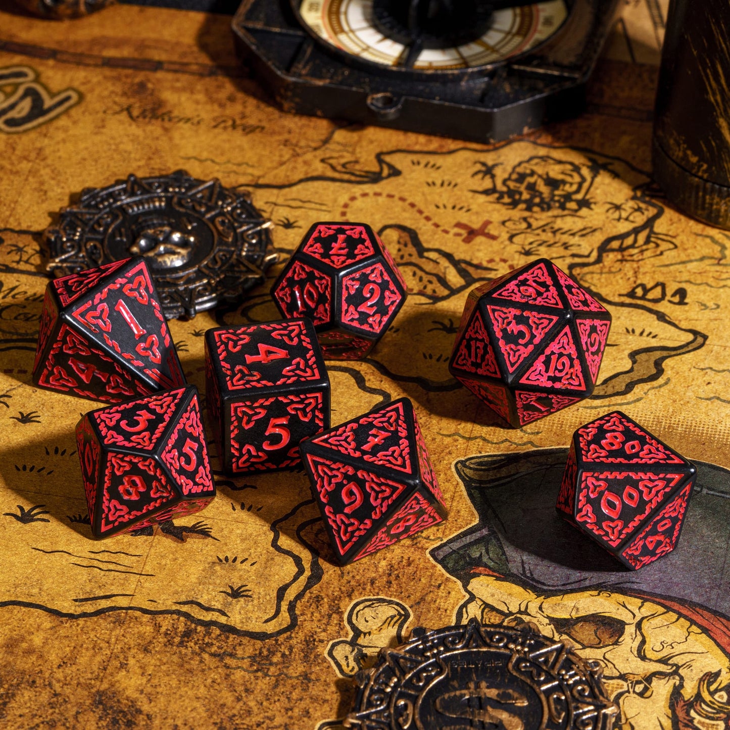 Celtic Knot Dice Set in black & red displayed on fantasy map with compass, 7 piece dice for DND & DND 5e