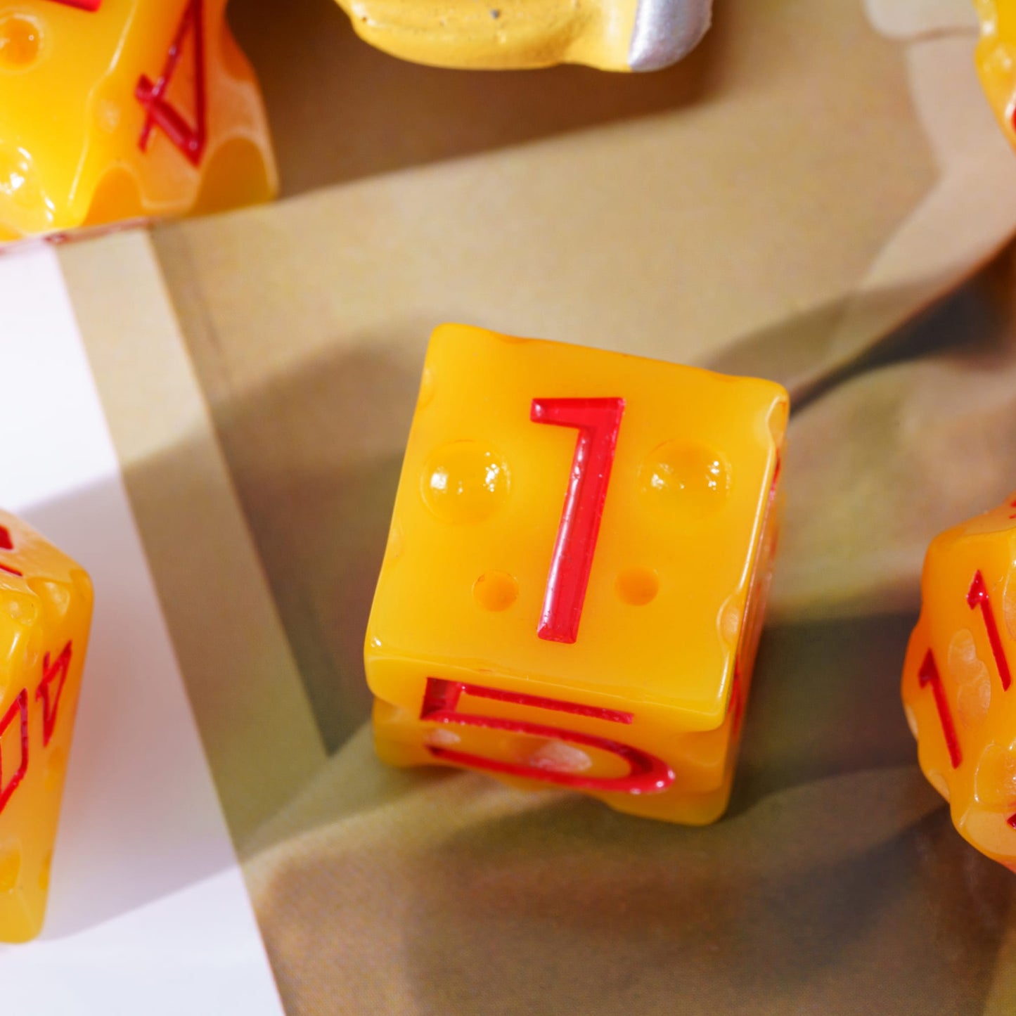Close-up of Cheese Dice Set D6, yellow die with red numbers for DnD & DnD 5e