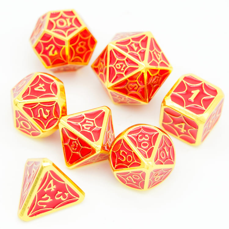 Top view of Crimson Gold Chroma polyhedral metal dice set on white
