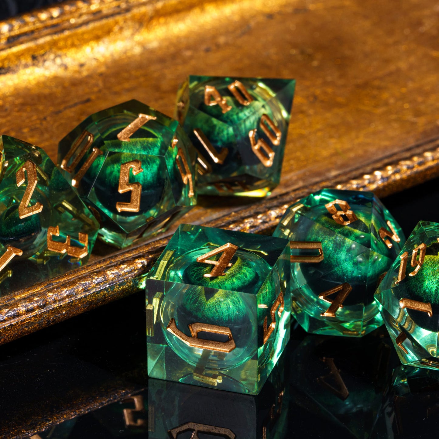 Green Dragon Eye dice set with gold ink numbers, close up D6 resin dice for DnD