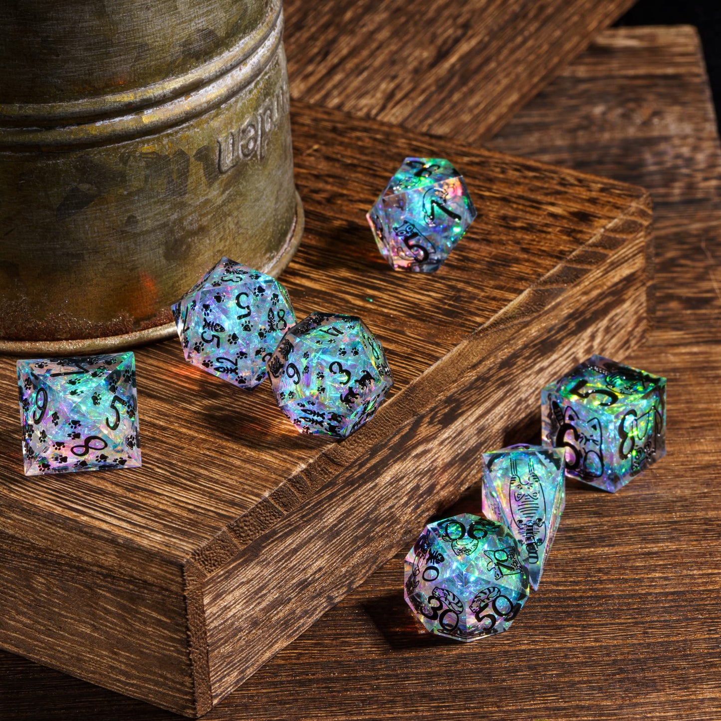 Feline Fantasy sharp edge polyhedral dice set displayed on wooden tabletop