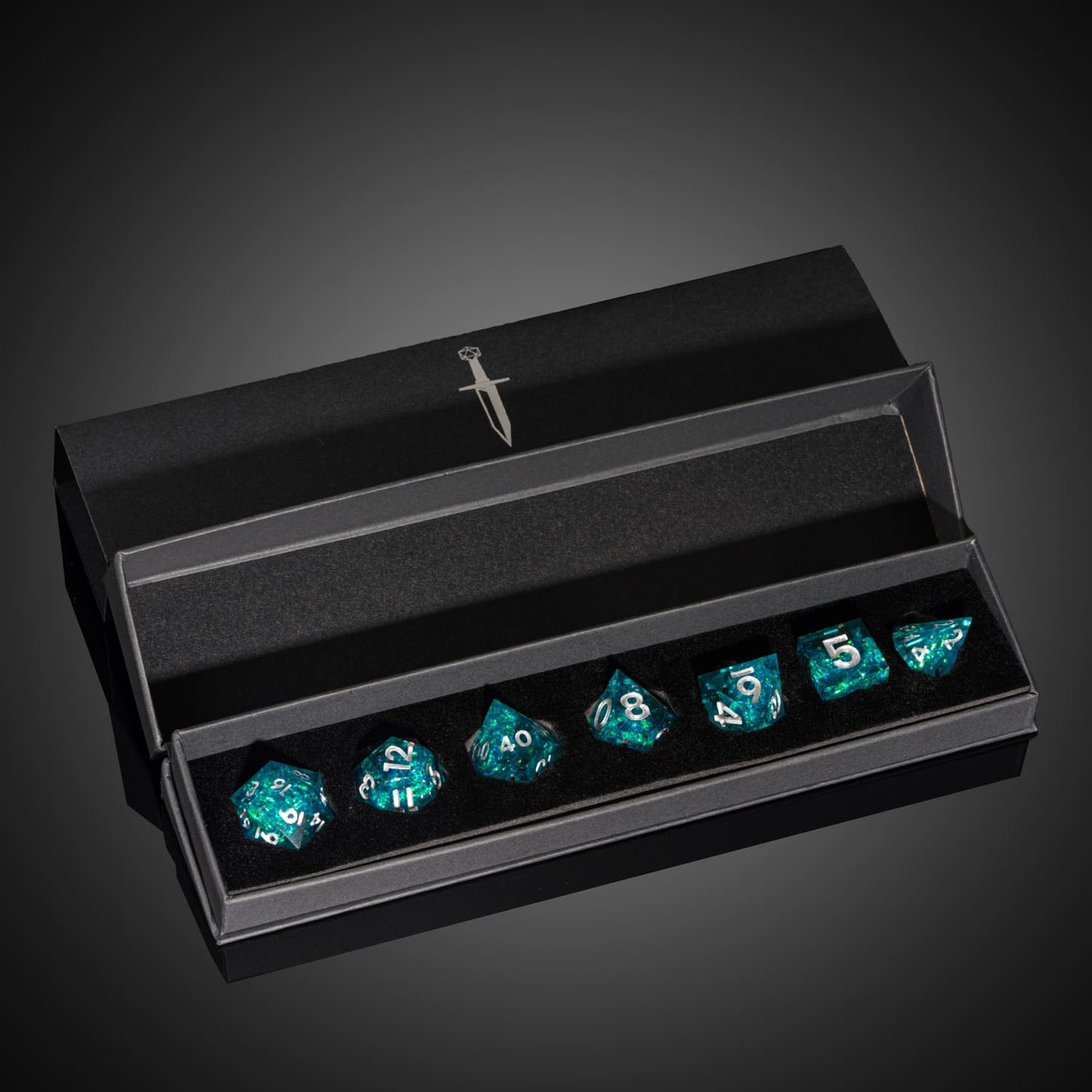 Icy Shard dice set displayed in black case for DnD and tabletop RPG, teal resin with silver numbering