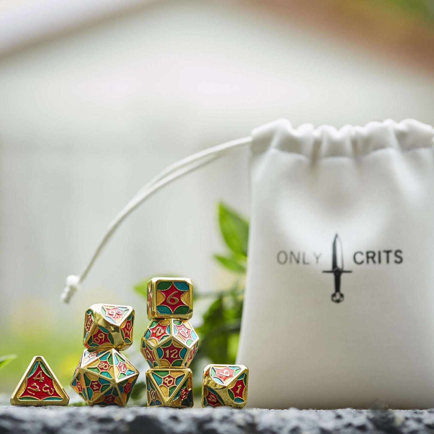 Jester Chroma dice set displayed with white Only Crits drawstring bag