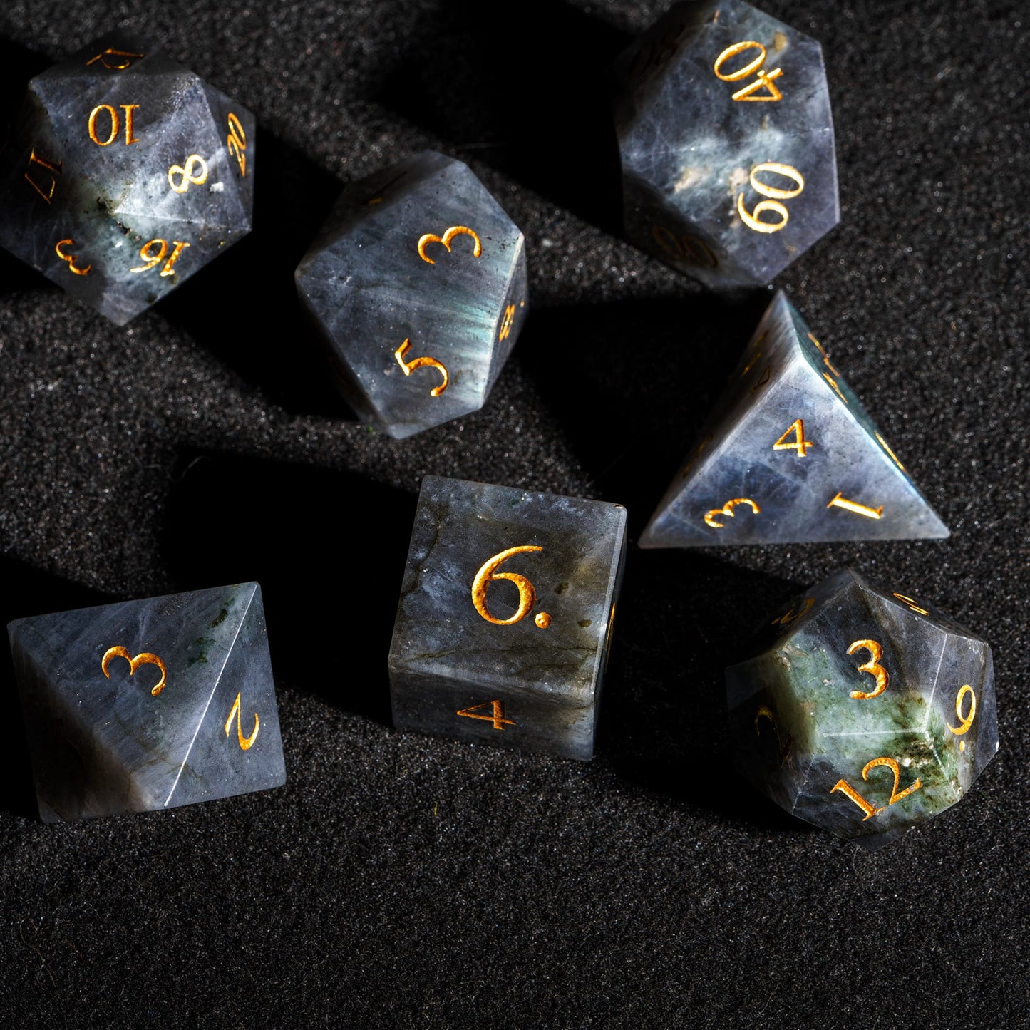 Top view of Labradorite Essence stone dice set featuring genuine labradorite gemstone dice with polished surfaces and gold numbering.