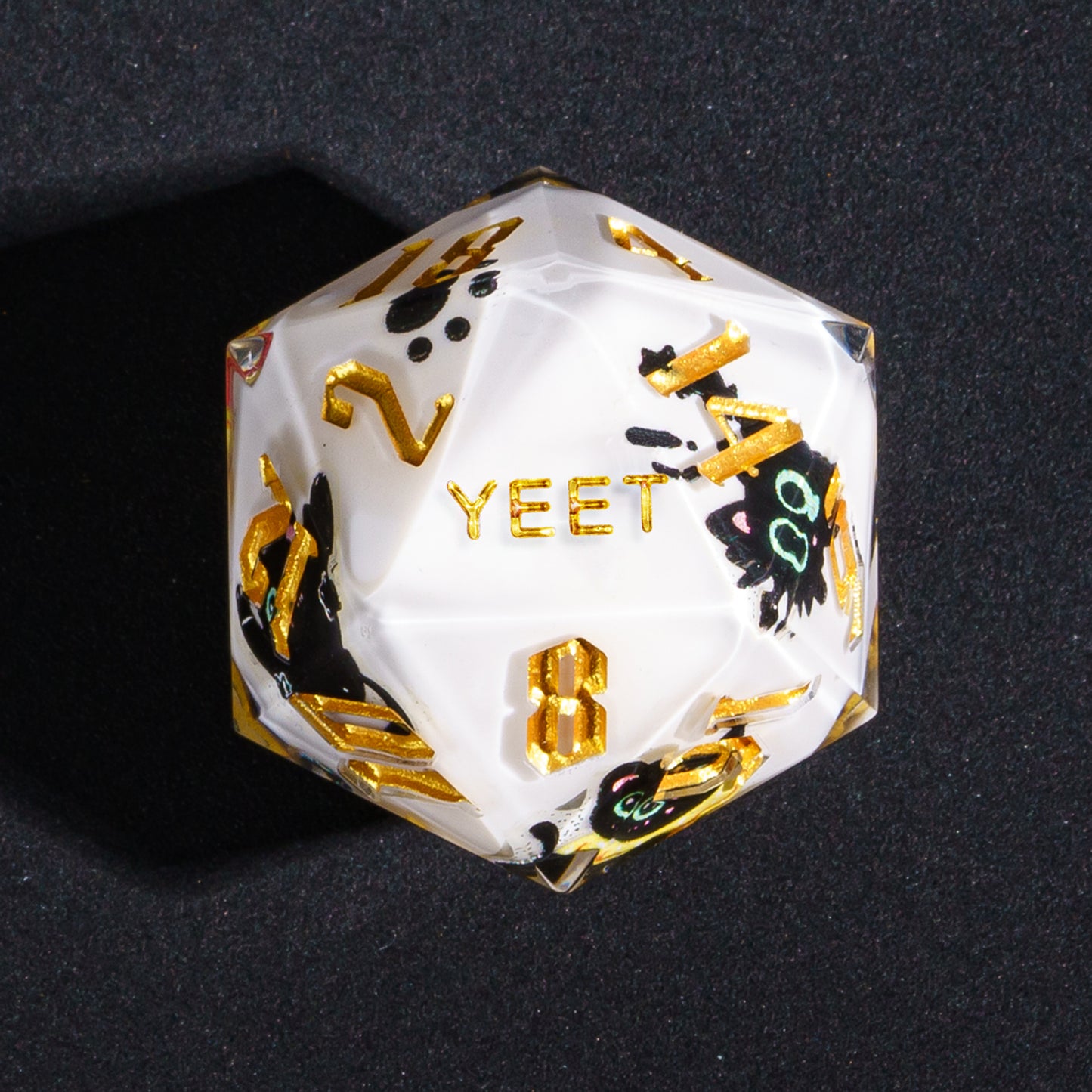 Close up of Nocturne Whiskers YEET D20 with black cat graphics and gold numbers for DnD
