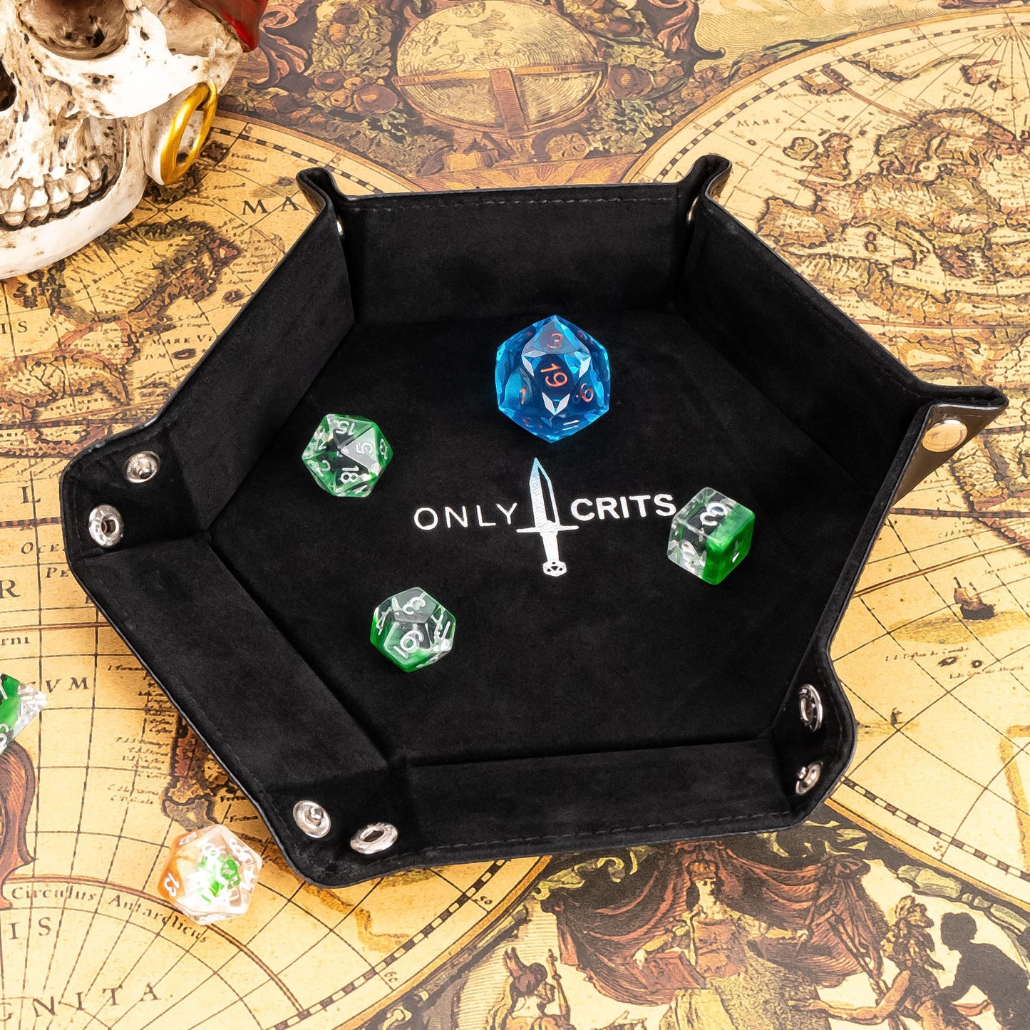 Black hexagon dice tray with Only Crits logo, holding colorful polyhedral dice on fantasy map