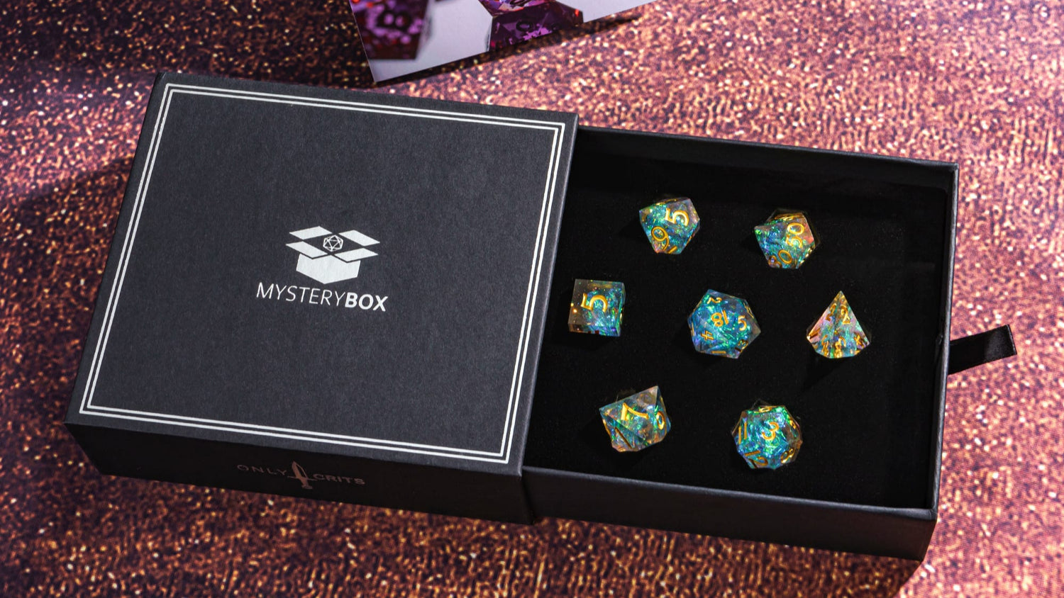 Opened Mystery Box from Only Crits showing random sharp-edge dice set purple glitter backdrop.