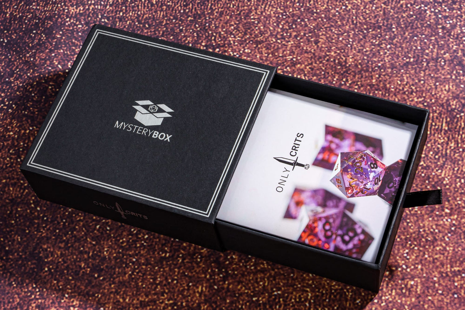 Only Crits Mystery Dice Box with branded insert and purple glitter background, packaging for random DND dice sets.