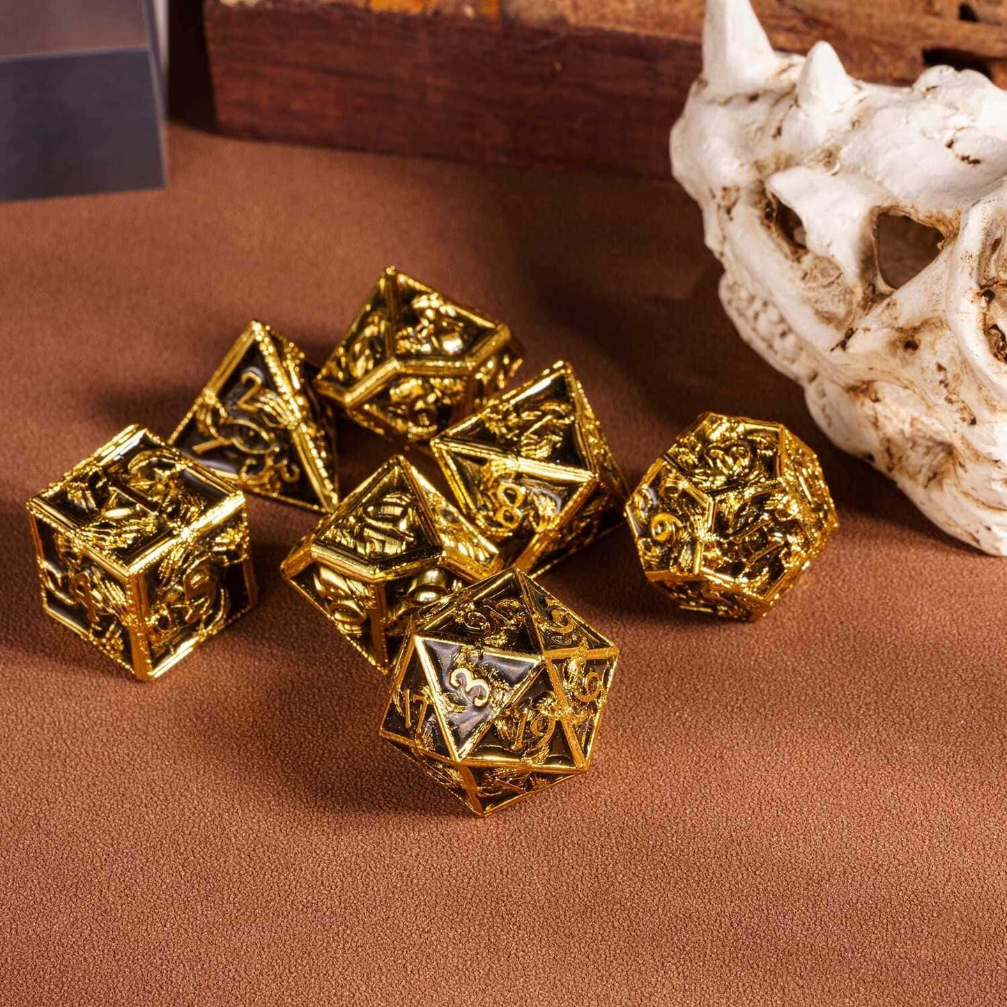 Onyx Crypt Metal Dice Set black & gold dice displayed on tabletop with skull