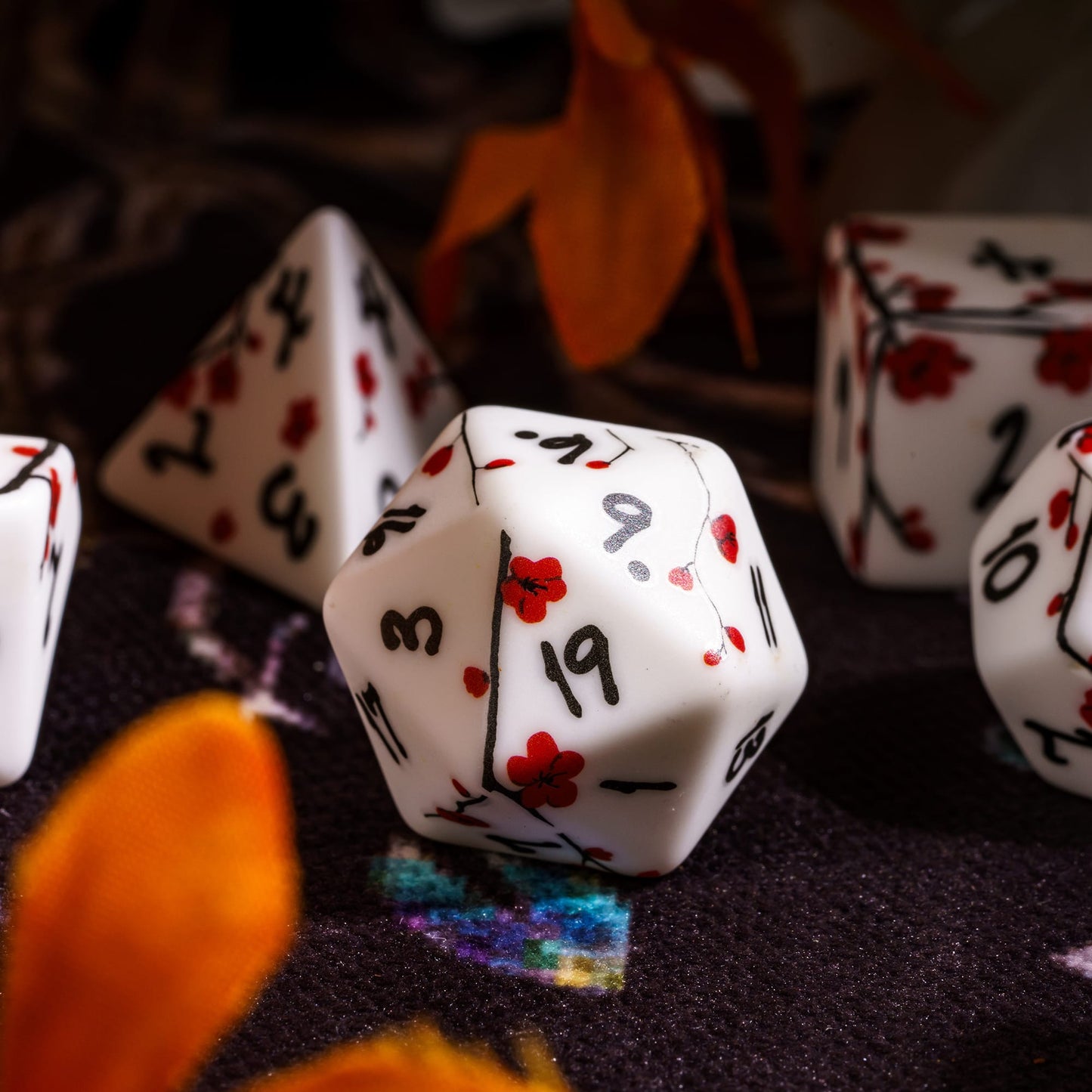 Closeup of Plum Blossom Dice Set D20 with red floral designs for DnD & DnD 5e