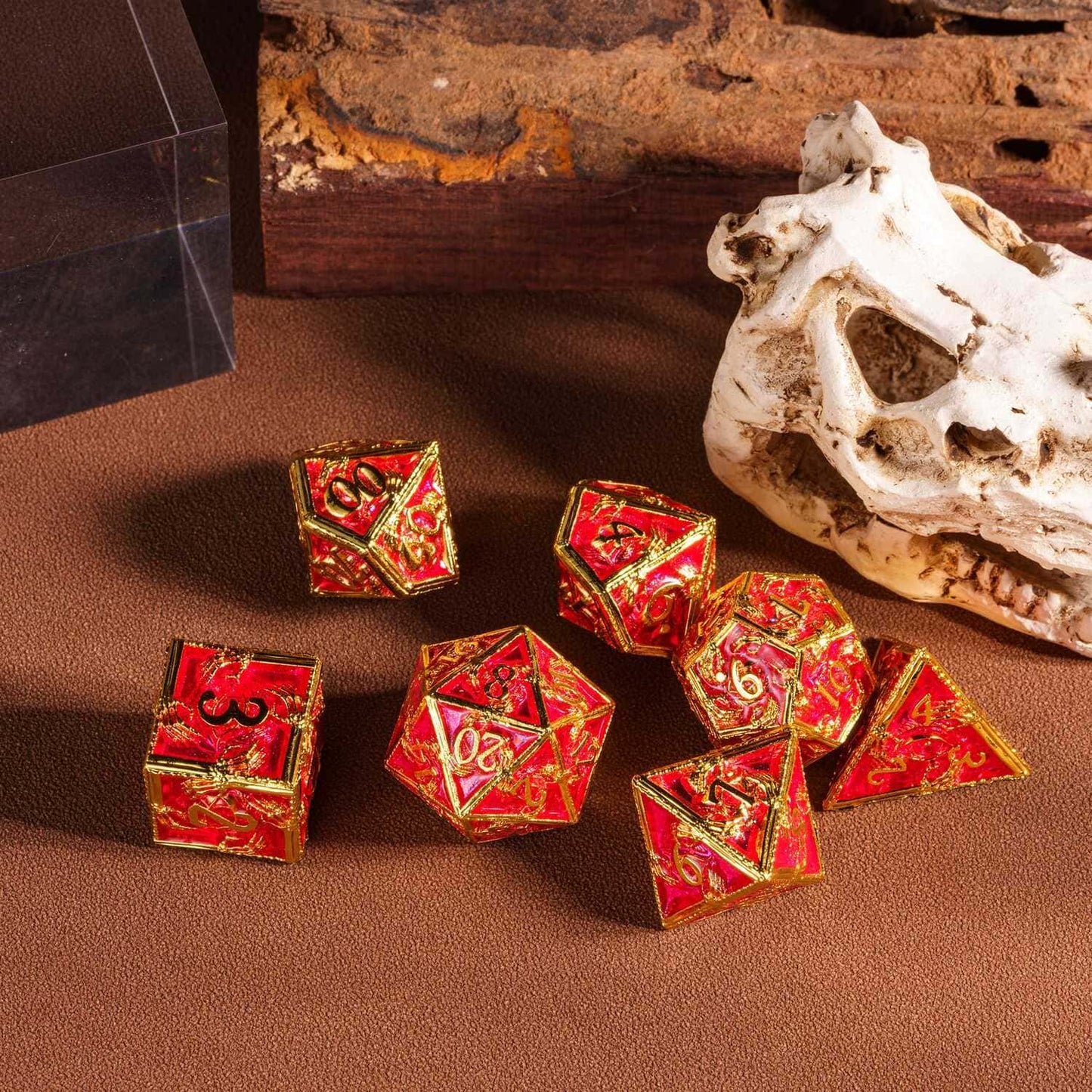 Royal Crypt Metal Dice Set red & gold RPG dice displayed on tabletop with skull