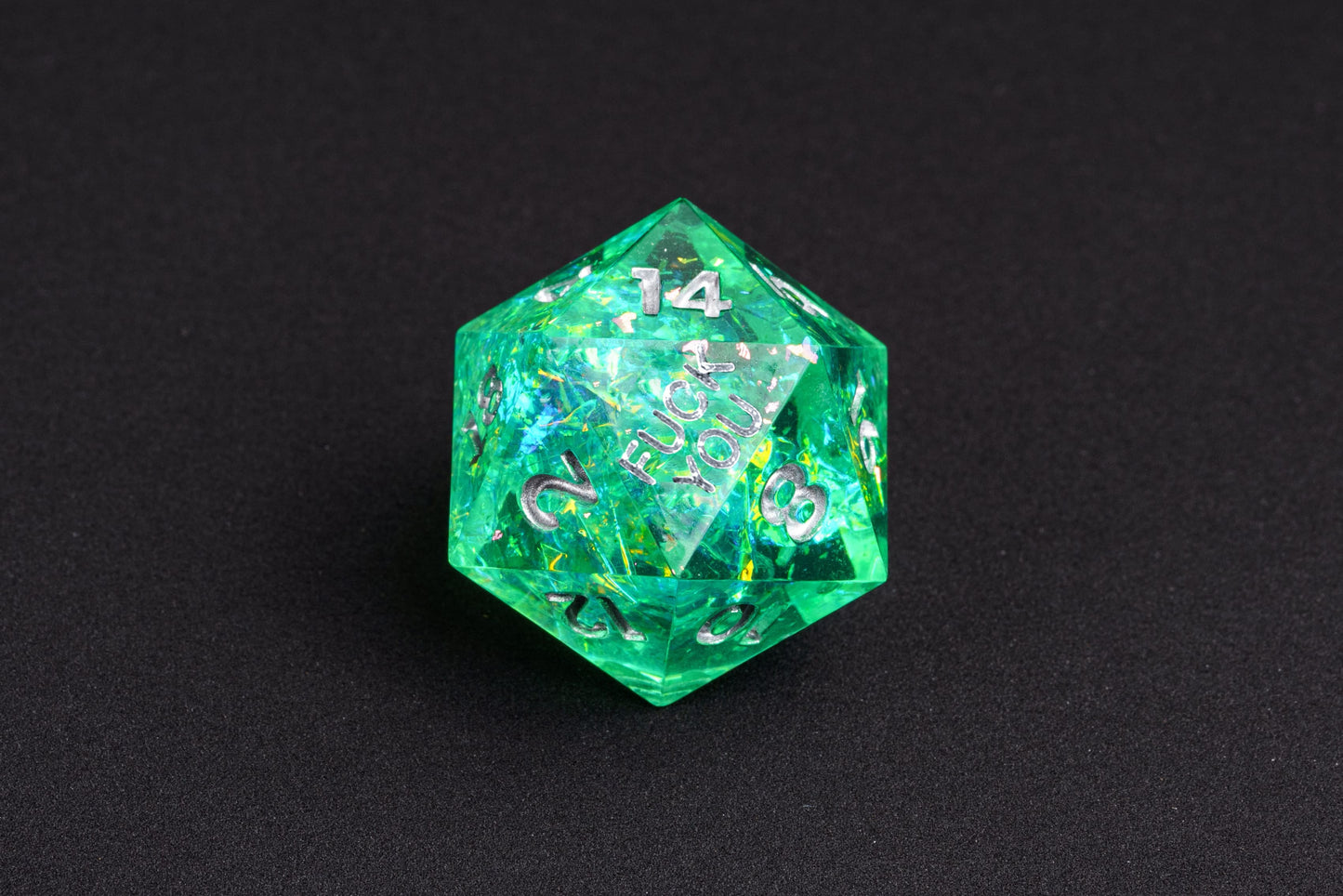 Closeup of Sages Emerald F*ck Me Sharp Edge Dice Set D20 with silver numbering for DnD & tabletop RPGs