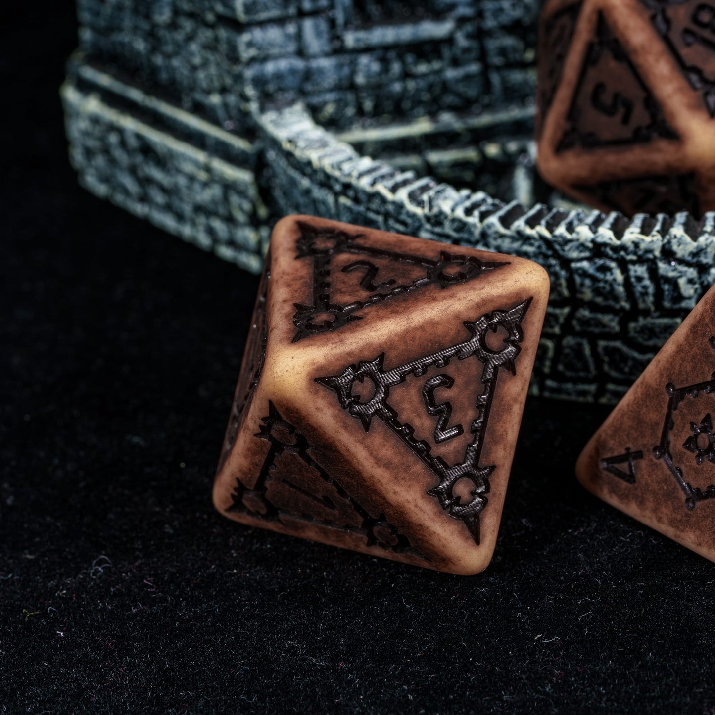 Close up of Sandy Elixir Chonk D4 resin dice for DnD and tabletop RPGs