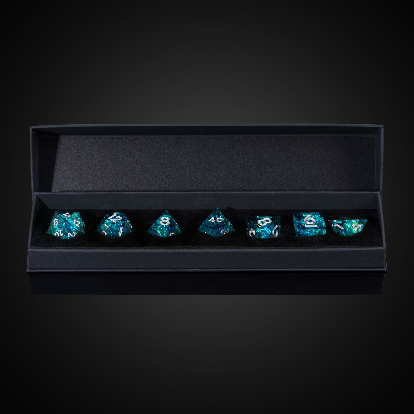 Turquoise Soul dice neatly arranged in black foam insert with box lid fully opened, premium RPG dice set