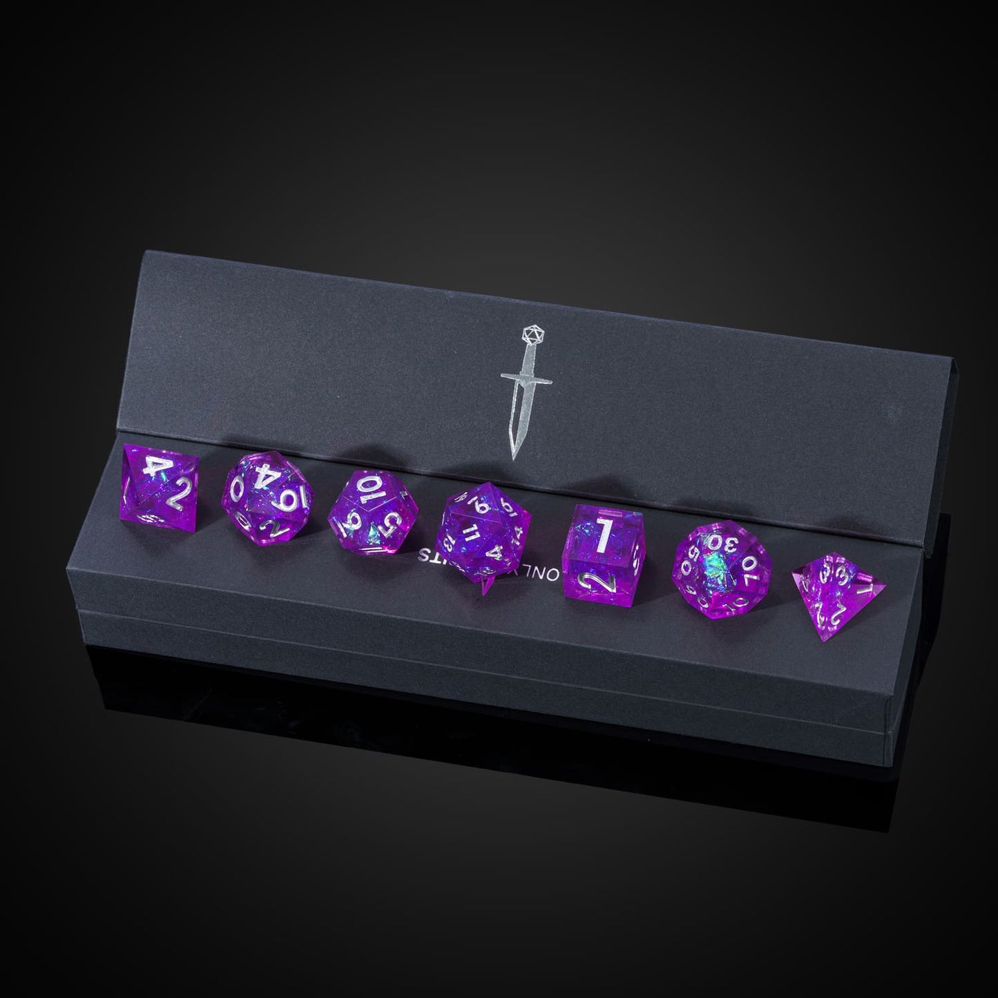 Violet Beam sharp edge dice displayed in black Only Crits box with sword logo, high-end TTRPG dice set