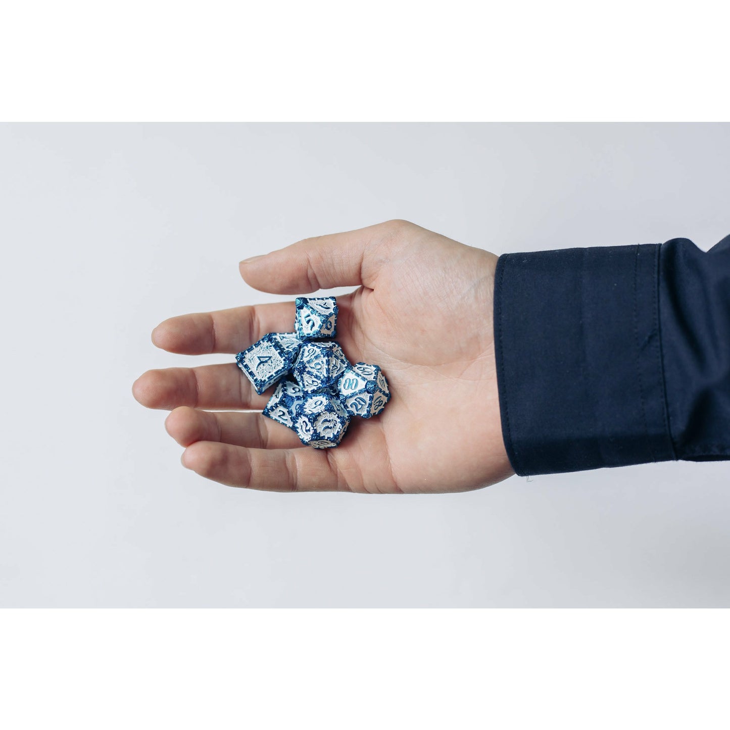 Icy Blade metal dagger dice set for DnD & TTRPG, held in hand