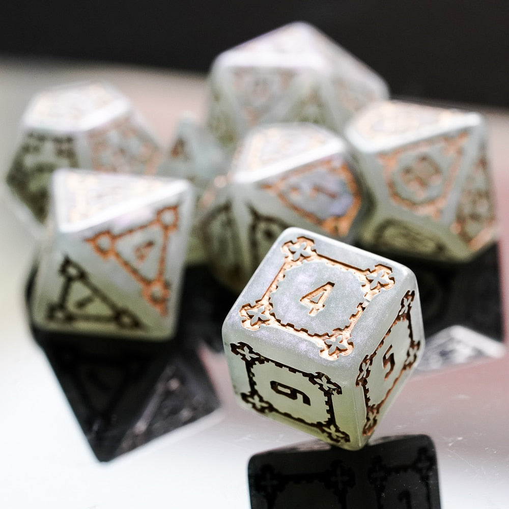 Detailed D6 from Moonlight Elixir dice set showing bronze framing and soft glow effect on reflective surface