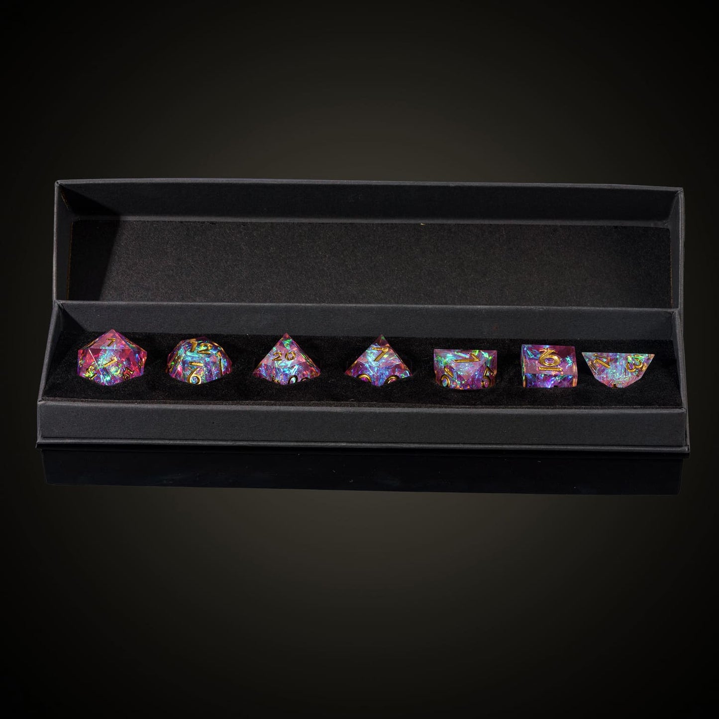 Boxed Celestial Heart dice set featuring pink sharp edge dice with gold numbers for DND and RPG games