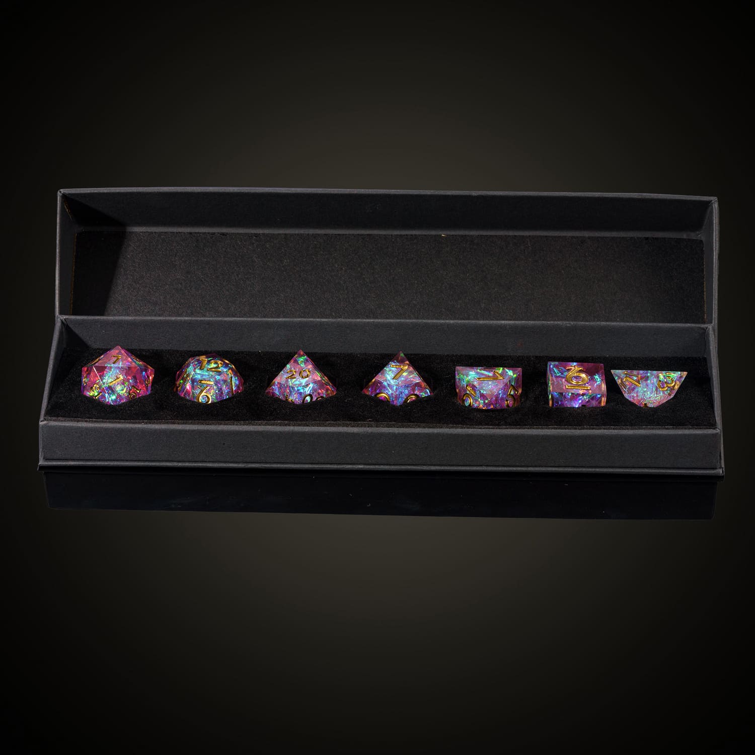 Boxed Celestial Heart dice set featuring pink sharp edge dice with gold numbers for DND and RPG games