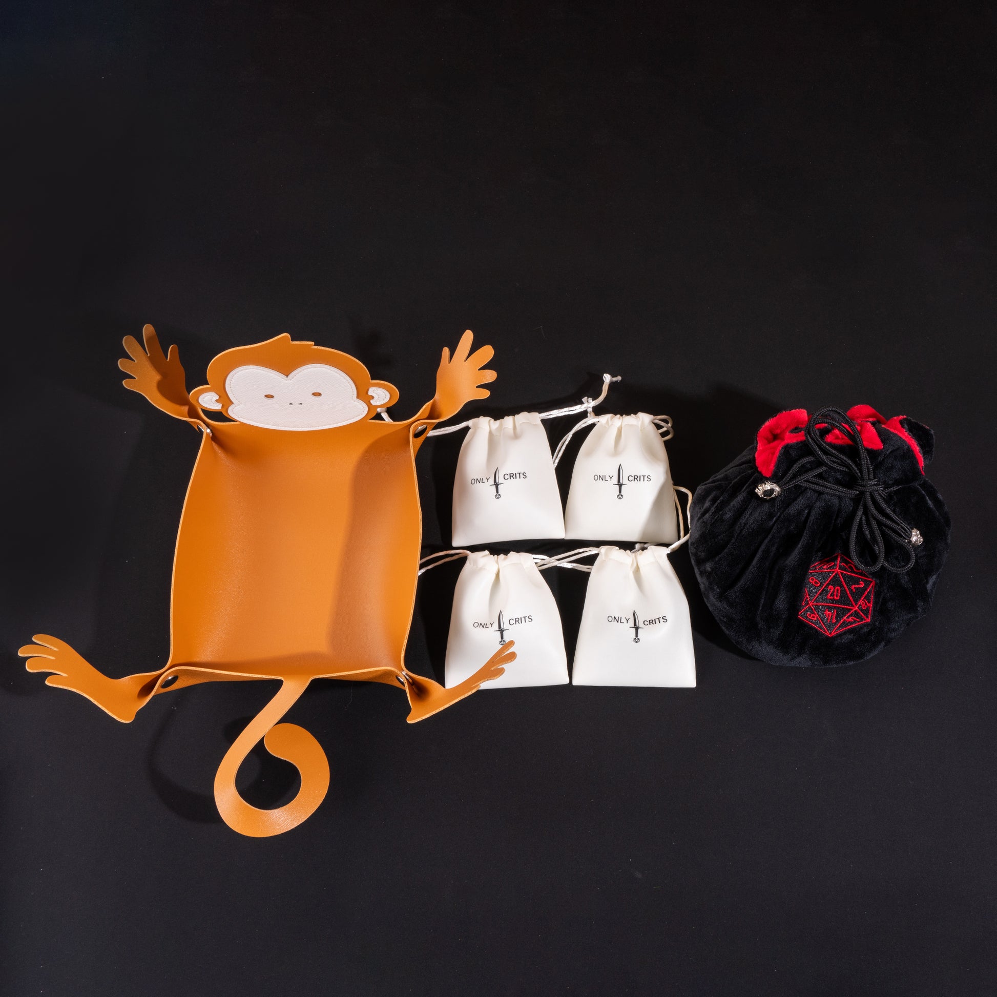 Little Friends Dice Bundle displaying the monkey-shaped dice tray, premium velvet dice bag, and four drawstring dice bags filled with colorful RPG dice.