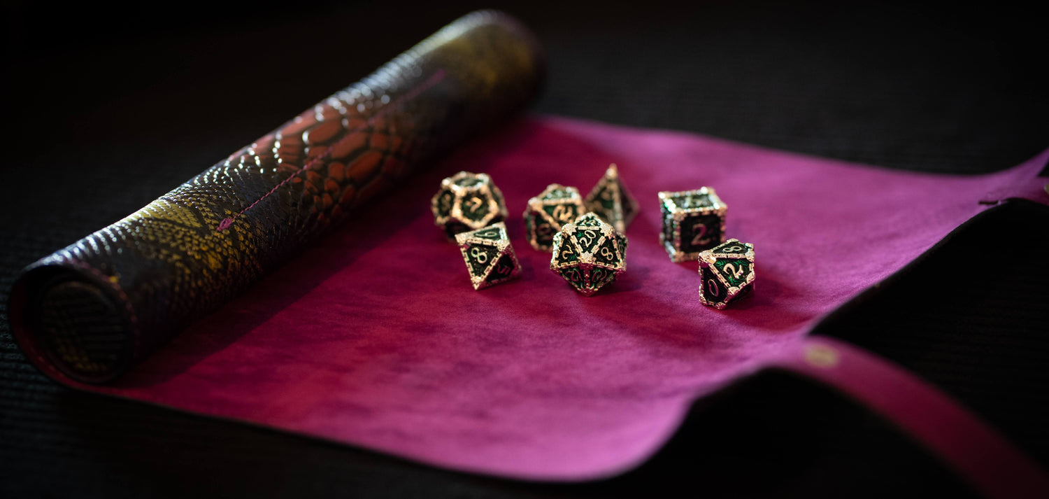 Emerald Blade - Metal Dagger Dice Set looks like an ornate metal dice set with green enamel on the open Dragon Spell Scroll – Dice Tray & Case