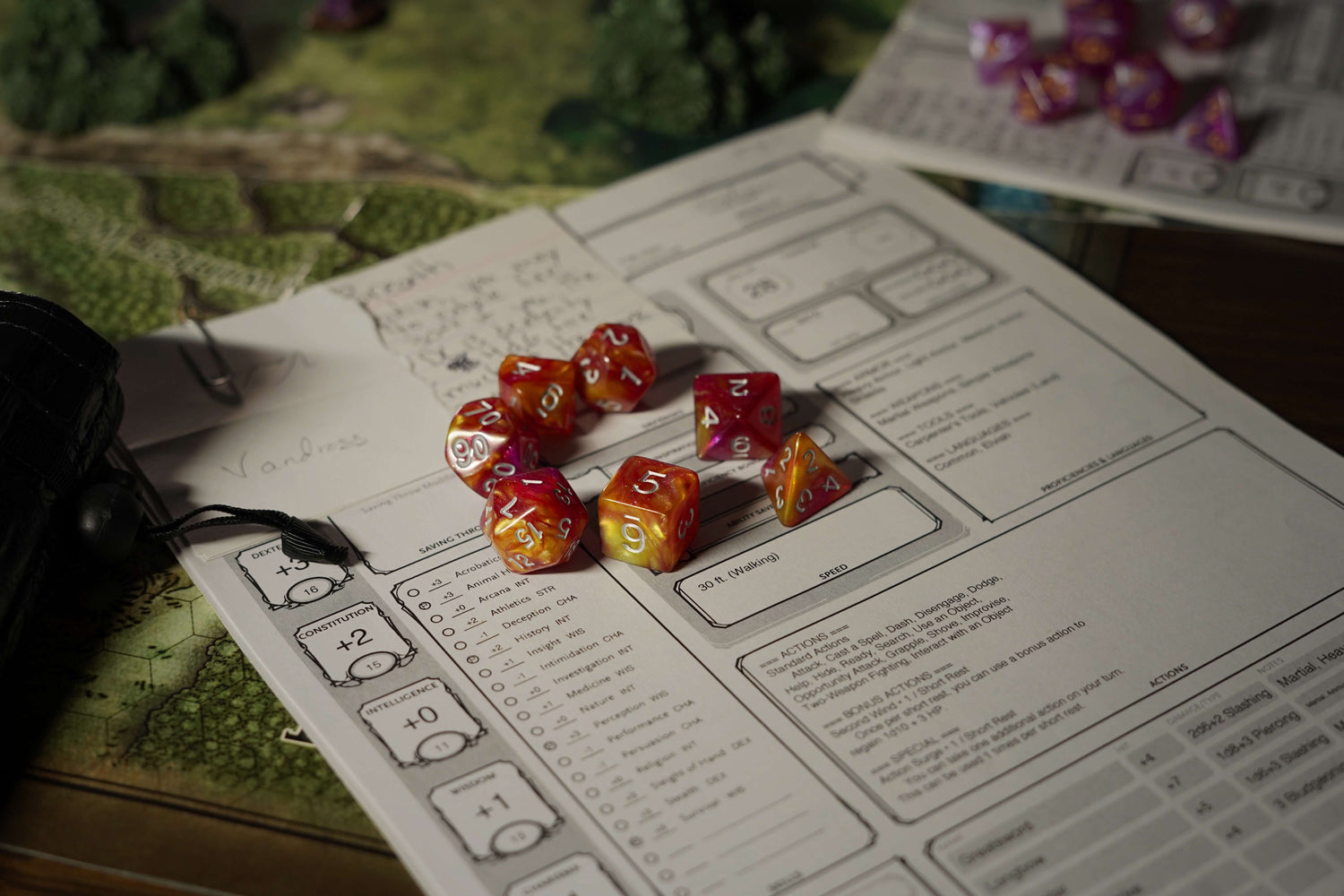 Swirled orange and yellow D&D dice from 'Dragon Eye - Multiple Dice Sets' on a character sheet during a tabletop RPG session