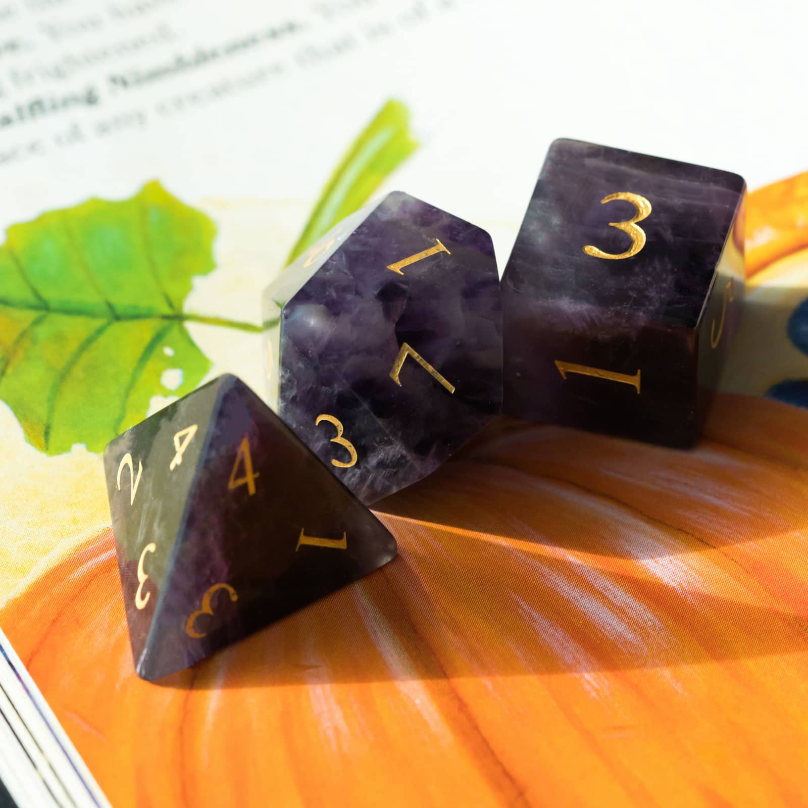 Close up of Amethyst Essence Stone Dice Set showing purple amethyst d4,d10 and d6