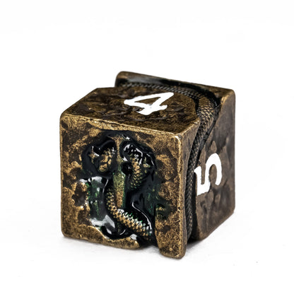 Close up of Ancient Bronze Serpent metal D6 with engraved serpent and antique bronze finish