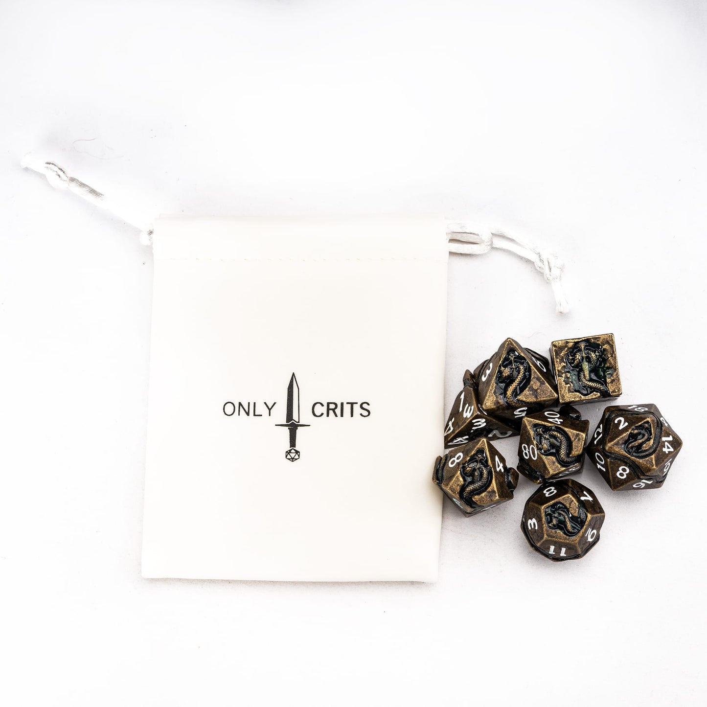 Ancient Bronze Serpent metal dice set with branded dice pouch flat lay for DnD and tabletop RPGs