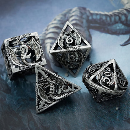 Close-up of Ancient Silver Dragon hollow metal dice set for DND and tabletop RPGs