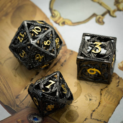 Close-up of Ancient Sparkled Meteor Hollow Metal Dice showing black dragon lattice design with gold numbering on map background