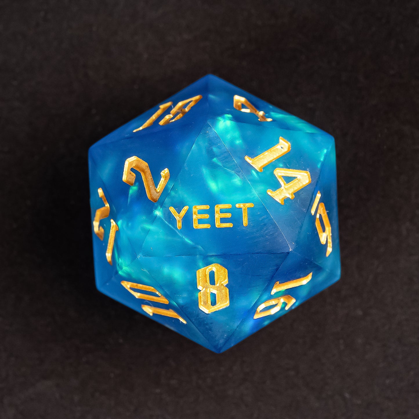 Close up of Azure Abyss Yeet Sharp Edge D20 with gold numbering for DnD & DnD 5e
