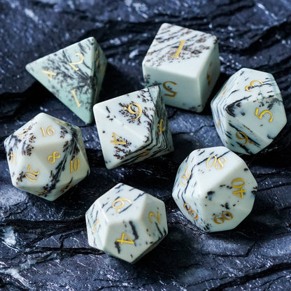 Full set of Birch Stonework Stone Dice displayed on black slate showing all seven polyhedral dice