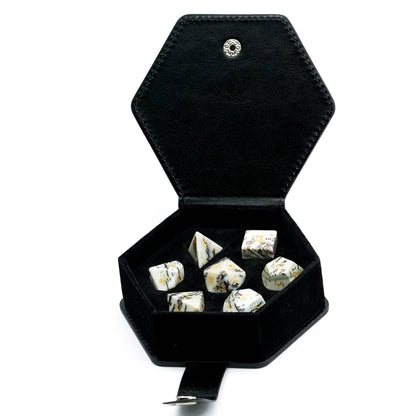 Birch Stonework Stone Dice Set arranged on reflective black surface showcasing natural veining