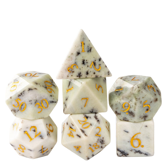 Natural stone dice set crafted from ivory-colored gemstone with dark birch-like veining and gold numbering, perfect for tabletop RPG adventures