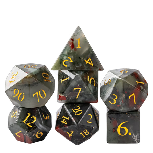 Blood Hex stone dice set crafted from dark natural gemstone with smoky gray tones, crimson red mineral accents, and gold numbering, designed for tabletop RPGs and fantasy adventures