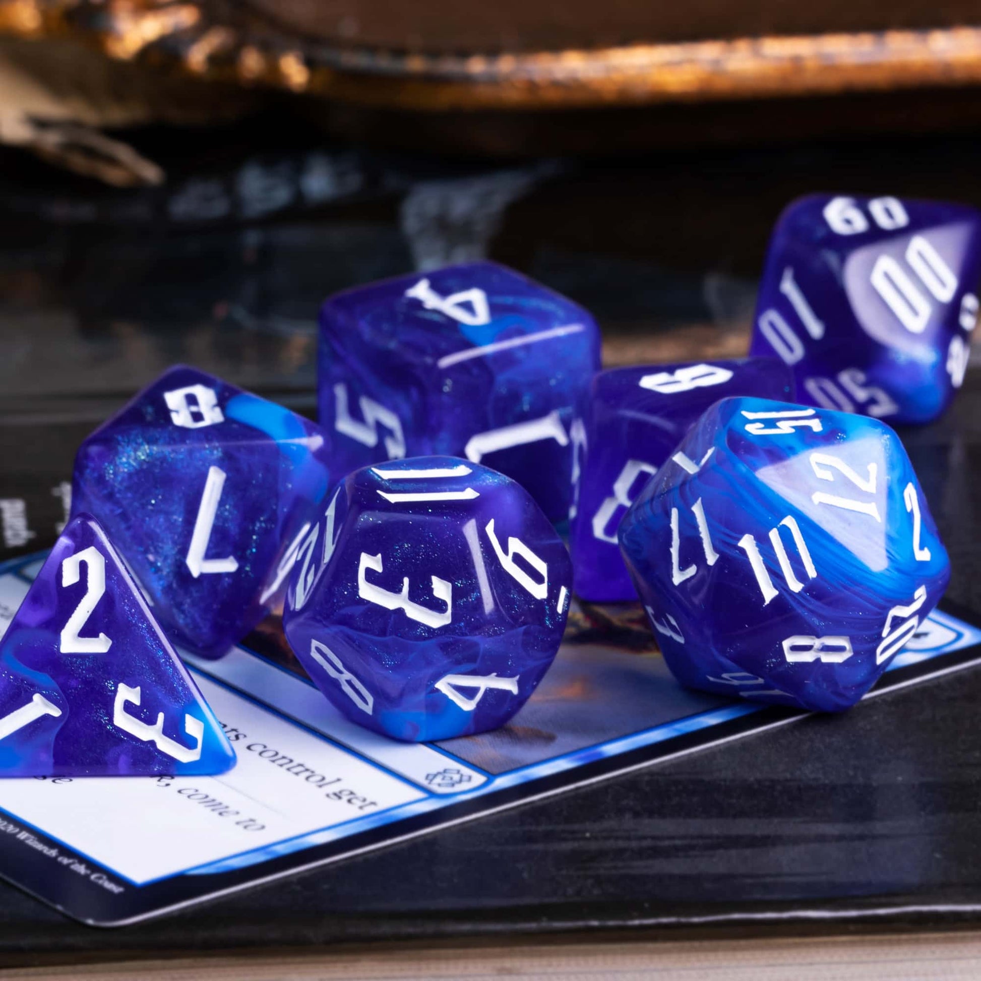 Blue Sapphire RPG dice set top down view with bold white numbering on white backgrounduse