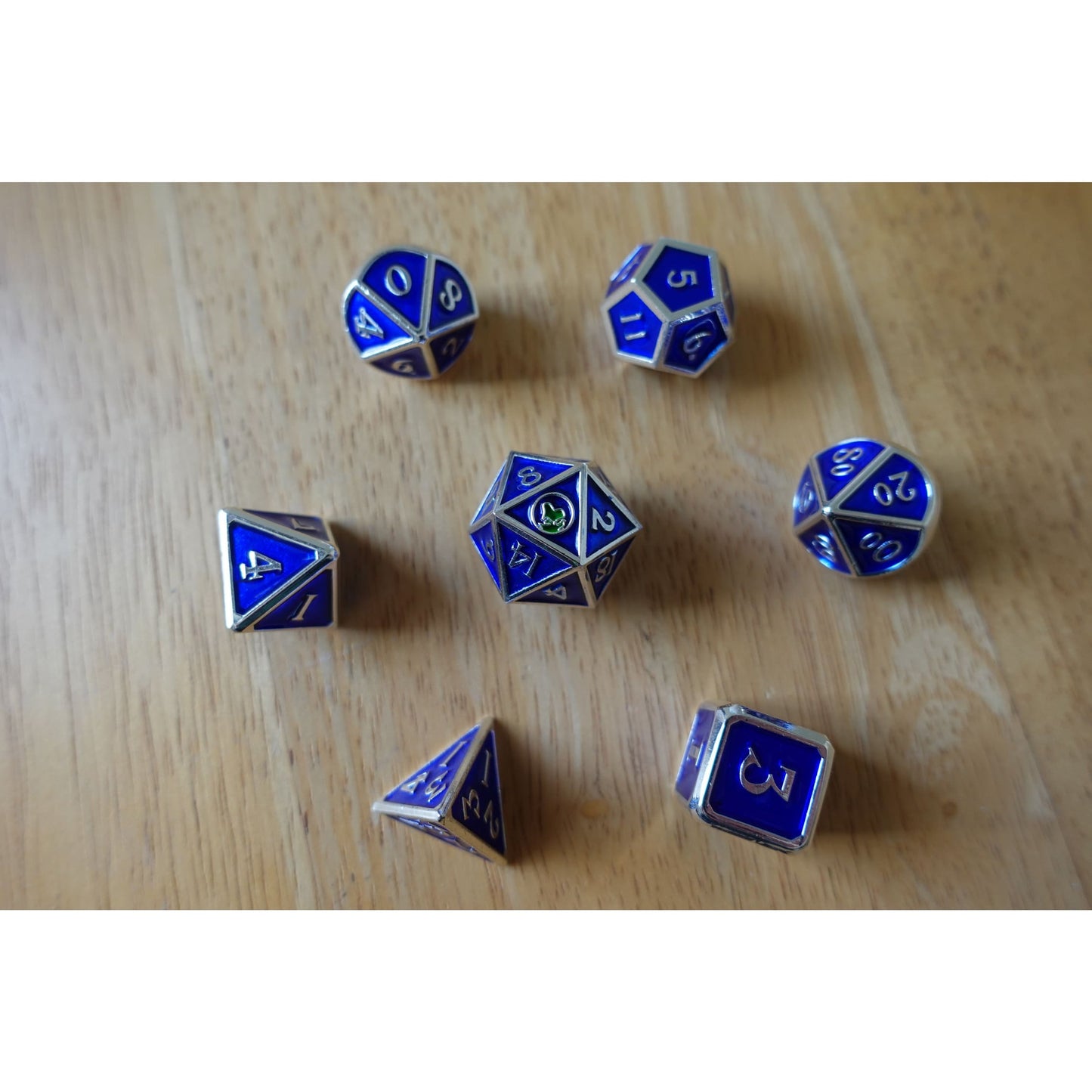 Full 7-piece Bob World Builder dice set in blue & silver laid out on wooden table