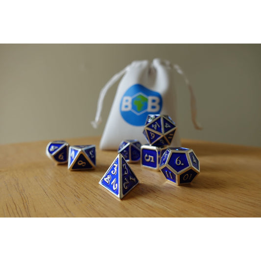 Blue & silver Bob World Builder dice set on wooden table with white dice bag in background