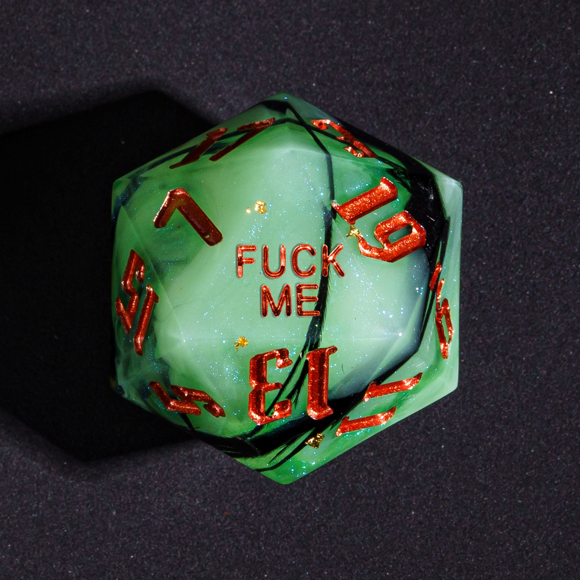 Close up Bog Hag Fuck Me D20 with green resin and red metallic ink