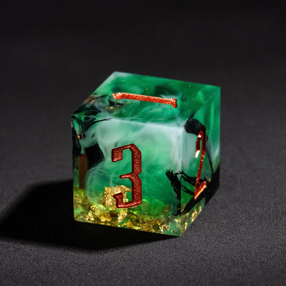 Close up of Bog Hag Sharp Edge D6 with green resin, black wisps, and copper engraved numbers