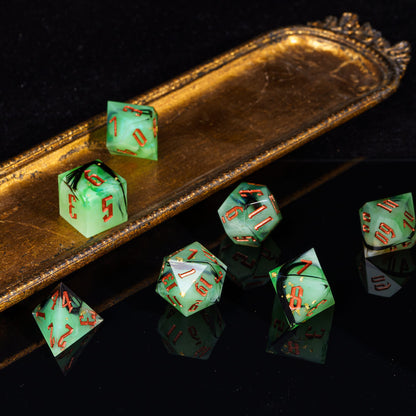 Bog Hag Sharp Edge Dice Set styled on gold tray with translucent green resin and copper numbers