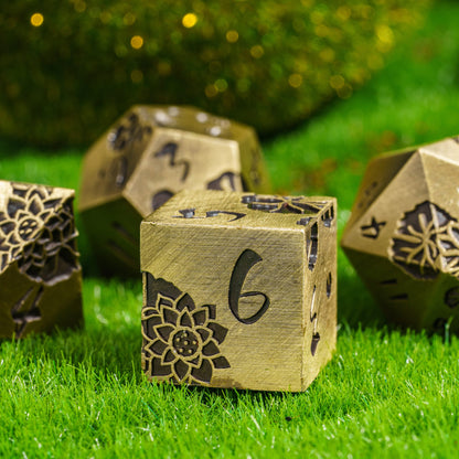 Close-up of Brass Lotus Blossom Metal D6 dice with floral cut design for DnD & DnD 5e